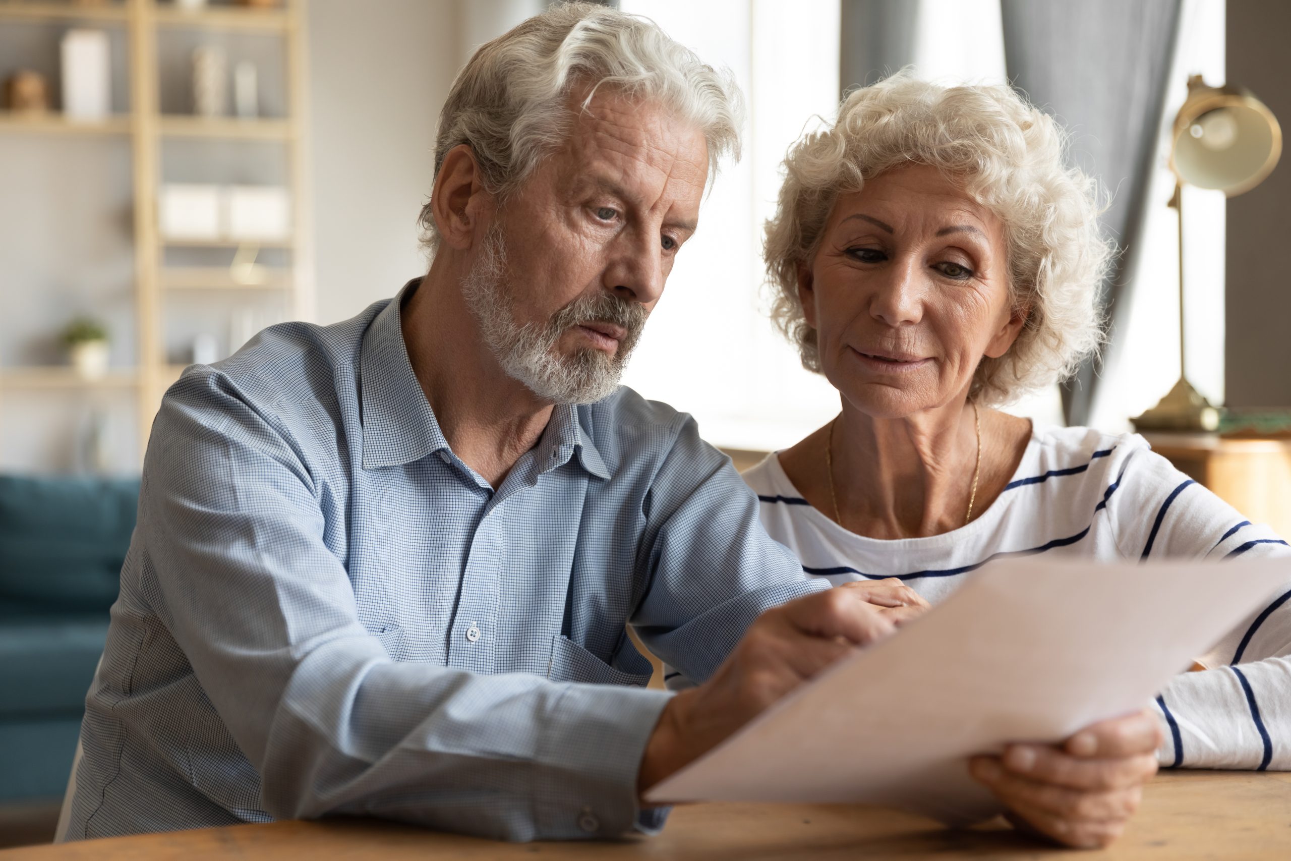 Focused,Elderly,70s,Married,Couple,Sit,At,Table,At,Home, Focused,Elderly,70s,Married,Couple,Sit,At,Table,At,Home,