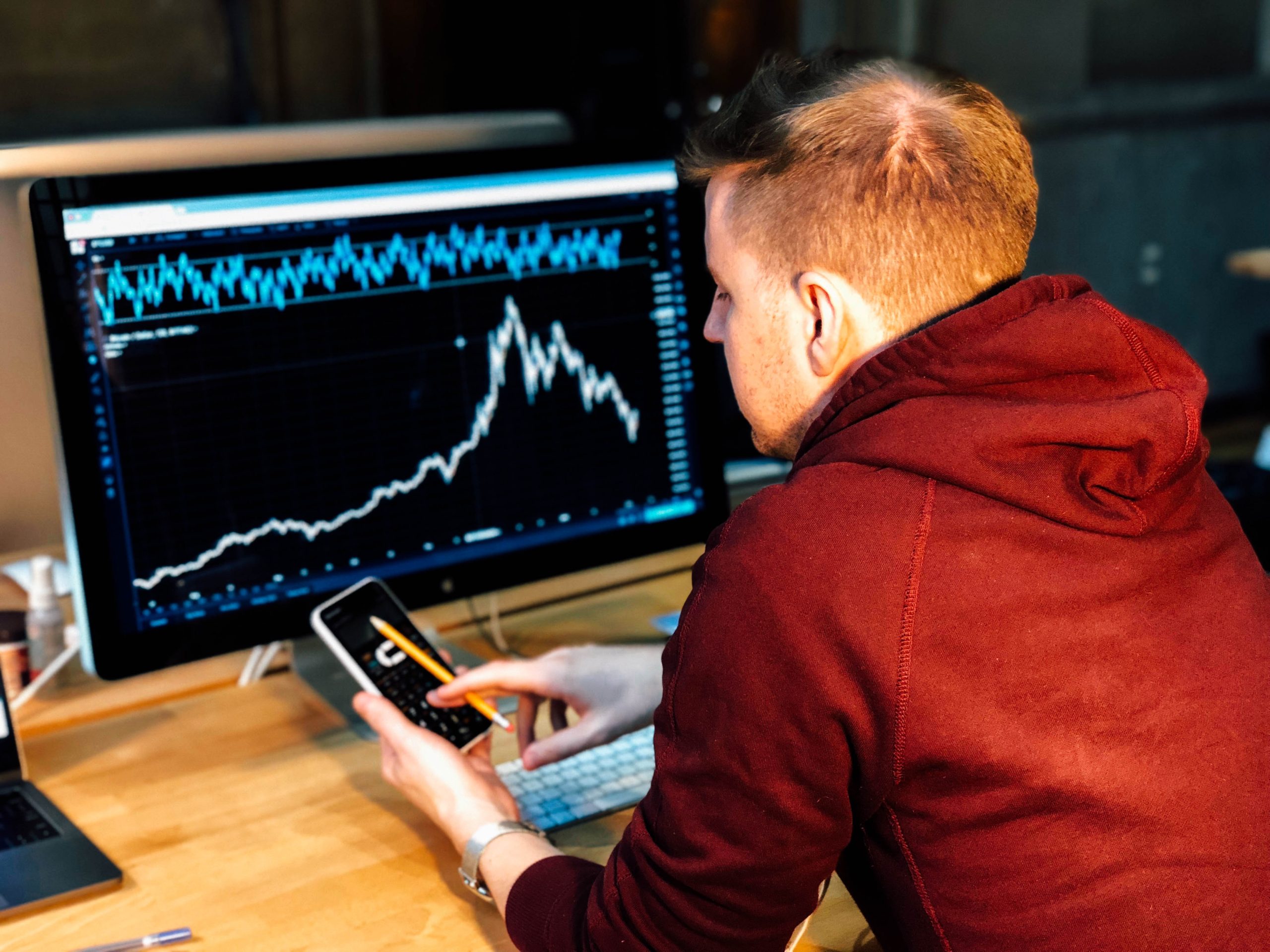 Man looking at stocks- computer Man looking at stocks- computer