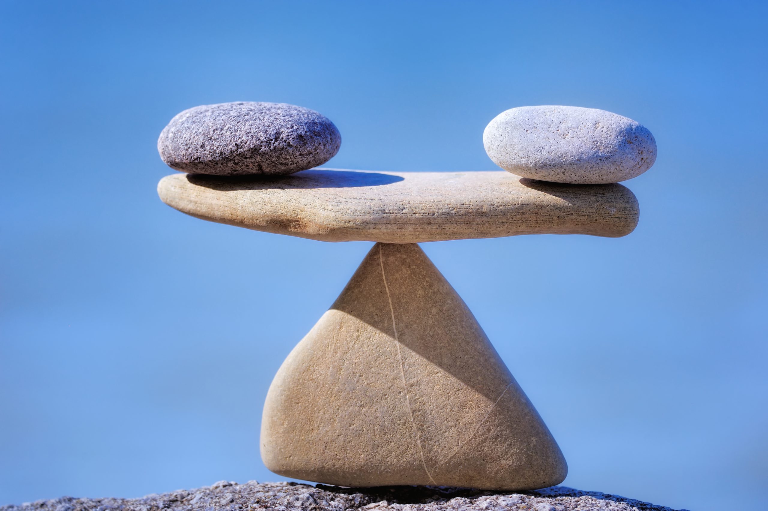 Oscillating Pair of scales is made of stones on the cliff
