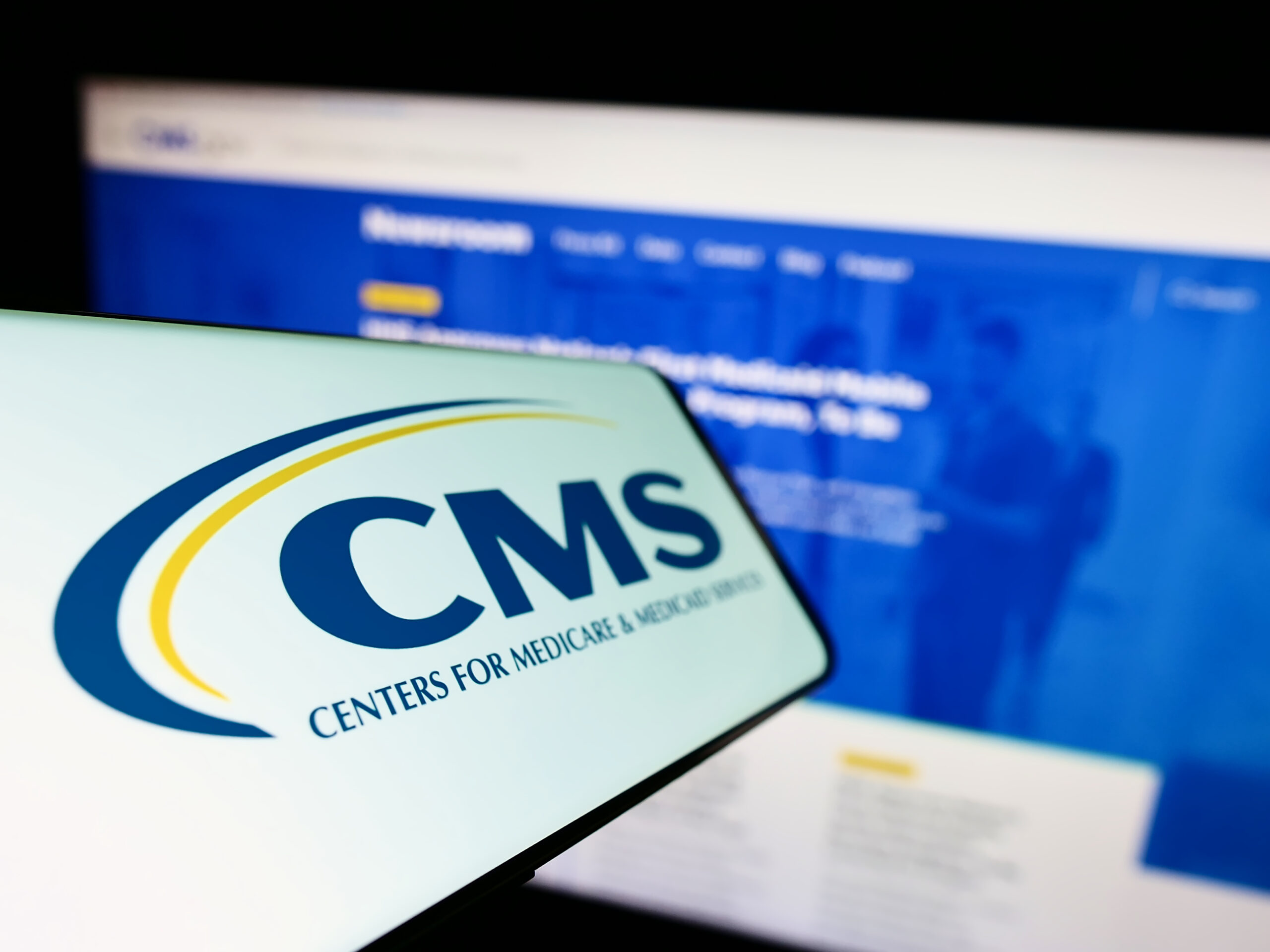 Stuttgart, Germany - 09-22-2022: Mobile phone with logo of Centers for Medicare and Medicaid Services (CMS) on screen in front of website. Focus on center-left of phone display.